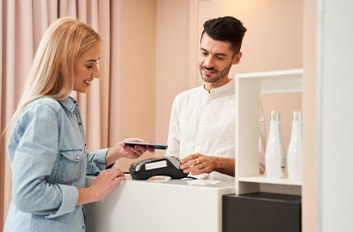 Patient using her phone to pay for cosmetic treatment