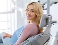 Woman smiling while sitting in treatment chair
