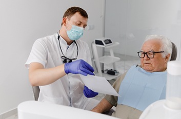 Dentist and patient looking at document together