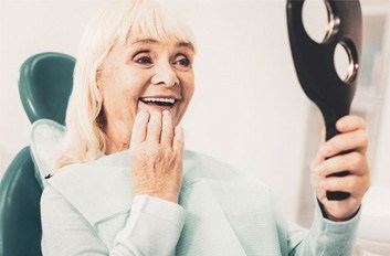 a patient checking her new dentures