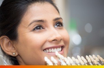 Woman trying on dental veneers from her cosmetic dentist in Brooklyn