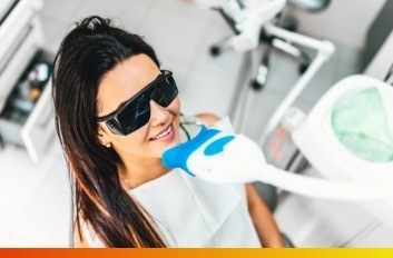 Woman receiving professional in office teeth whitening