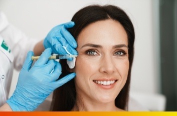 Dentist giving a female patient Botox injections