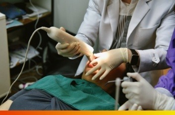 Dentist taking digital dental impressions of a patient's mouth