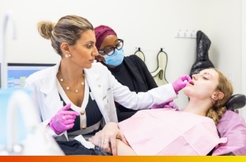 Young woman in yellow blouse smiling in dental chair