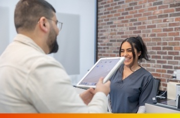 Two people looking at dental insurance information on a tablet