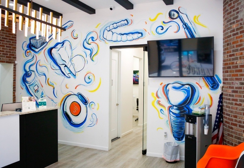 Dentistry themed mural on wall of Brooklyn dental office waiting room