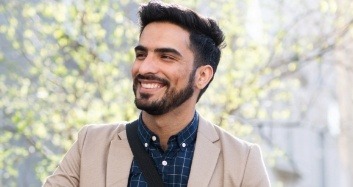 Man in beige dinner jacket smiling after dental services in Brooklyn