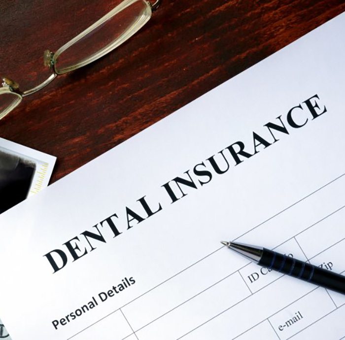 Form that says “dental insurance” on a desk