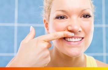 Woman looking at her gums in her reflection