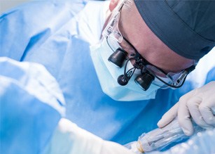 an oral surgeon performing dental implant surgery