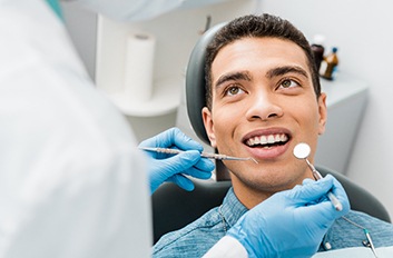 Patient smiling at dentist during dental checkup