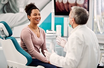 Smiling patient talking to dentist during checkup
